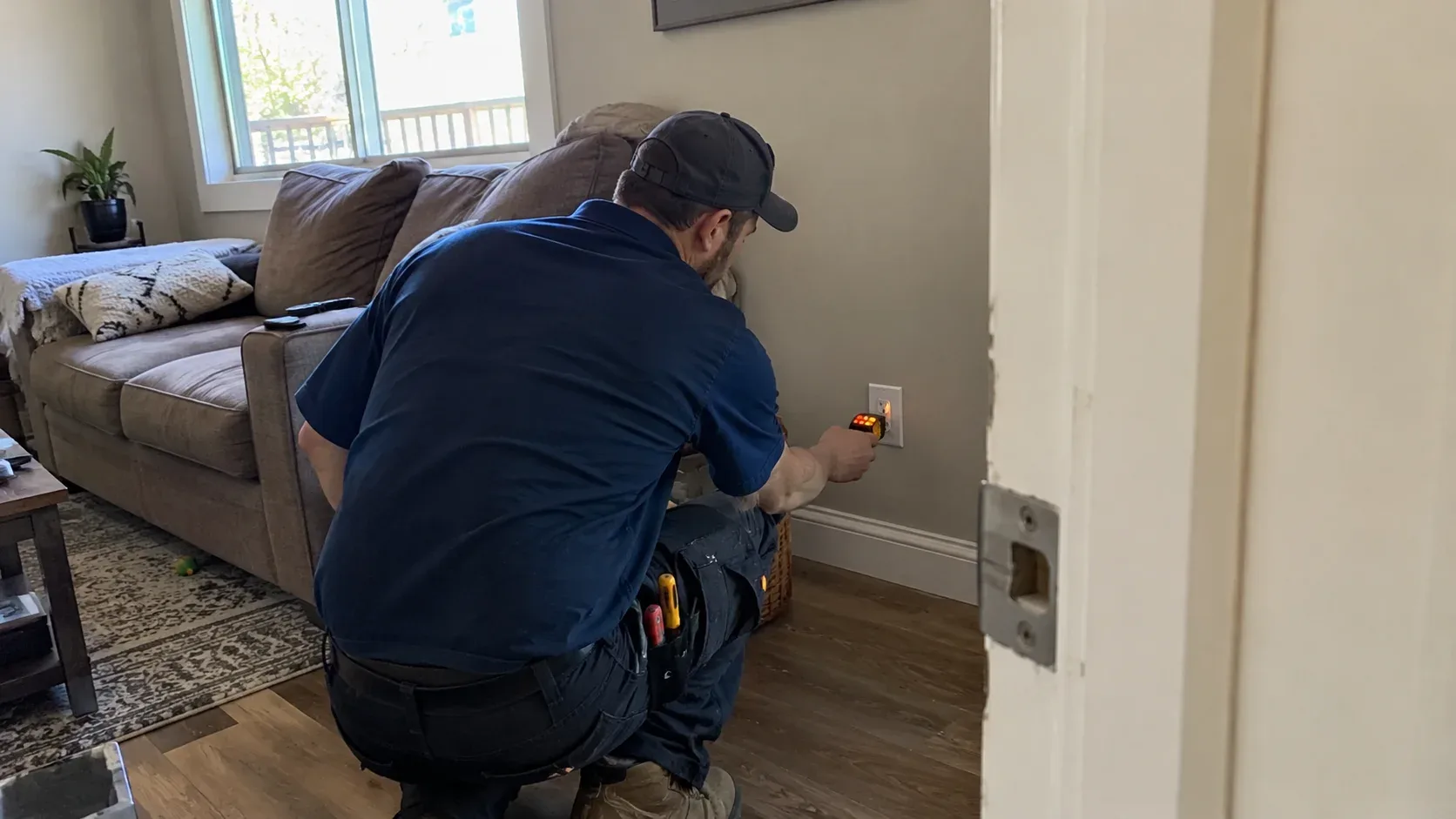 Electrician using a voltage tester to investigate a residential circuit with partial power loss